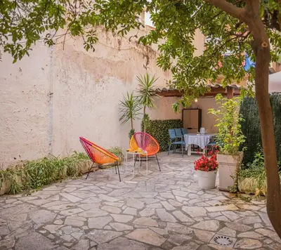 a patio with two chairs and a table in a courtyard at Charmant 4 pièces - Cour privative - Port de Nice in Nice