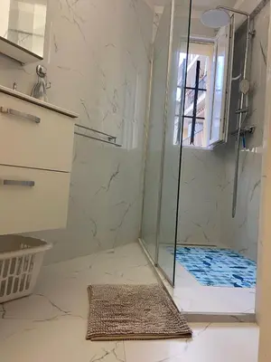 a shower with a glass door in a bathroom at Superbe 3 pièces près du Port de Nice in Nice