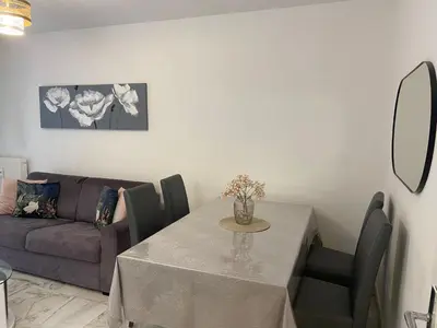 a living room with a table and a couch at Superbe 3 pièces près du Port de Nice in Nice