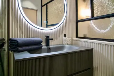 a bathroom with a sink and a mirror at Nice Mer & Cours Saleya Serenity Luxury - 2 suites in Nice