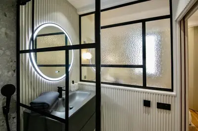a bathroom with a sink and a mirror at Nice Mer & Cours Saleya Serenity Luxury - 2 suites in Nice