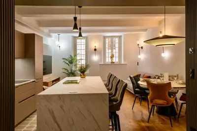 a kitchen and living room with a table and chairs at Nice Mer & Cours Saleya Serenity Luxury - 2 suites in Nice
