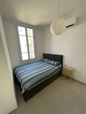 a small bedroom with a bed and a window at Cosy flat 250m from beach in Nice