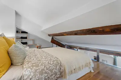a bedroom with a bed with a wooden at Nice Renting - 3 MASSENA - Chic Escape Luxury Duplex Place Massena in Nice