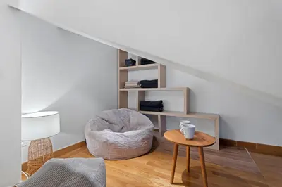 a living room with a chair and a table at Nice Renting - 3 MASSENA - Chic Escape Luxury Duplex Place Massena in Nice