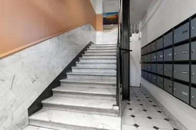 a staircase in a house with white marble tiles at Nice Renting - 3 MASSENA - Chic Escape Luxury Duplex Place Massena in Nice