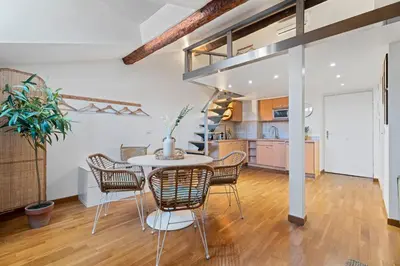a kitchen and dining room with a table and chairs at Nice Renting - 3 MASSENA - Chic Escape Luxury Duplex Place Massena in Nice
