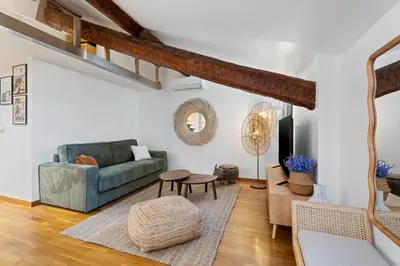 a living room with a couch and a table at Nice Renting - 3 MASSENA - Chic Escape Luxury Duplex Place Massena in Nice