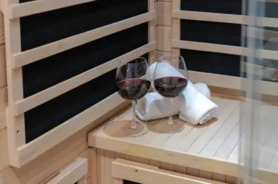 two glasses of red wine sitting on a table at Lavie Maison Sauna and Hot Tub Seaside in Nice