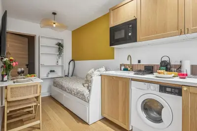 a kitchen with a washer and dryer in a room at Lavie Maison Hot Tub Seaside Studio in Nice