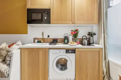 a kitchen with a washer and dryer in a kitchen at Lavie Maison Hot Tub Seaside Studio in Nice
