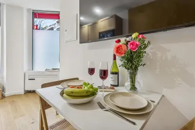 a table with plates and glasses of wine and flowers at Lavie Maison Hot Tub Seaside Studio in Nice