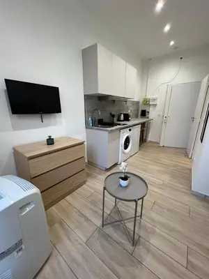 a small kitchen with a small table in a room at Studio Sydney - Jean Médecin - LA RIVIERA LCD in Nice