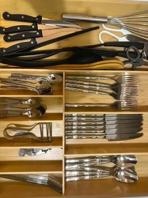 a wooden drawer filled with lots of kitchen utensils at Chez Yaya in Nice