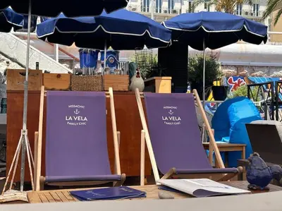 two purple lawn chairs sitting on a table with an umbrella at Chez Yaya in Nice