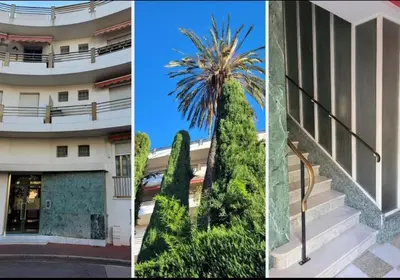 a building with a palm tree in front of it at Spacieux appartement à Nice 4 chambres in Nice
