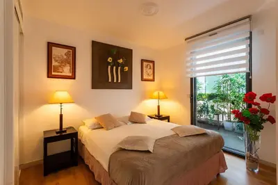 a bedroom with a bed with two lamps and a window at Nice SuiteMarie Carre d'or in Nice