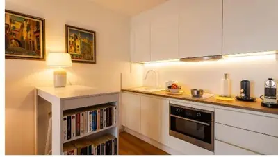 a kitchen with white cabinets and a counter top at Nice SuiteMarie Carre d'or in Nice