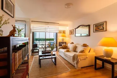 a living room with a white couch and a large window at Nice SuiteMarie Carre d'or in Nice