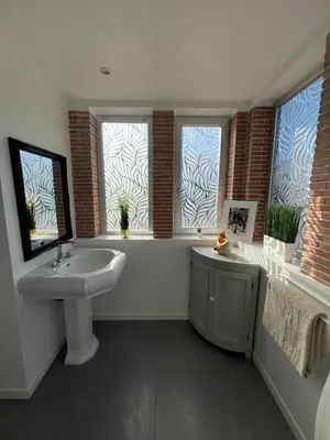 a bathroom with a sink and a tub and two windows at Superbe villa piscine proche ville et mer au calme in Nice
