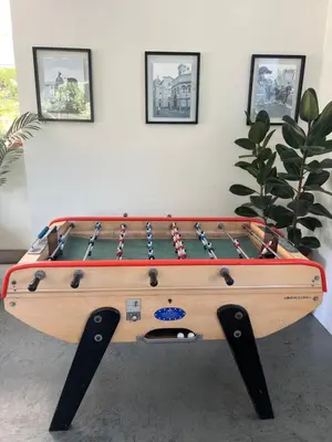 a wooden foosball table in a room with at Superbe villa piscine proche ville et mer au calme in Nice