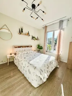 a white bedroom with a large bed and a window at Superbe villa piscine proche ville et mer au calme in Nice