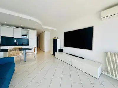 a living room with a flat screen tv on a wall at Art de vivre sur la Promenade in Nice