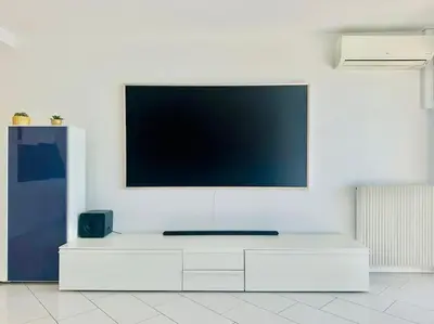 a flat screen tv on a white wall at Art de vivre sur la Promenade in Nice