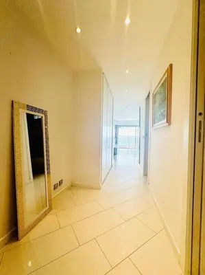 a hallway with a mirror on the wall in a building at Art de vivre sur la Promenade in Nice