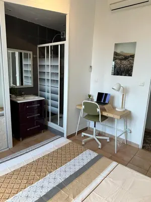 a room with a desk and a laptop on a table at Maison de ville à Nice Ouest dans propriété arborée in Nice