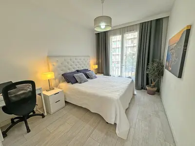 a bedroom with a bed and a desk and a chair at Gorgeous Oceanfront Apartment Promenade in Nice