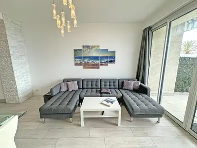 a living room with a couch and a table at Gorgeous Oceanfront Apartment Promenade in Nice