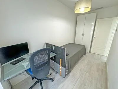 a bedroom with a desk and a bed with a computer at Gorgeous Oceanfront Apartment Promenade in Nice