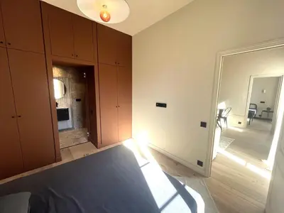a room with wooden cabinets and a room with a mirror at Beaumont republique in Nice