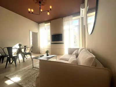 a living room with a white couch and a table at Beaumont republique in Nice