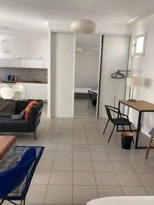 a living room with a couch and a table at L'Appartement Bleu in Nice