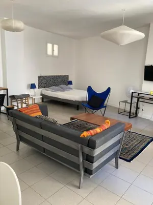 a living room with a couch and a bed at L'Appartement Bleu in Nice