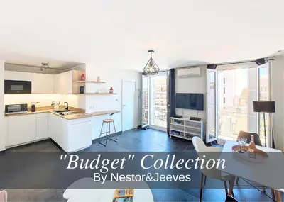 a kitchen with white cabinets and a large window at Nestor&Jeeves - GIOFFREDO BELLO - central - near beach in Nice