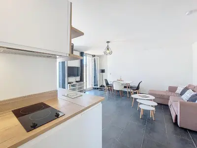 a kitchen and living room with a couch and a table at Nestor&Jeeves - GIOFFREDO BELLO - central - near beach in Nice