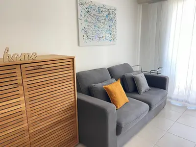 a living room with a couch and a dresser at Appartement Nice Carré d Or in Nice