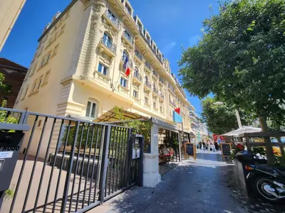 a large yellow building on the side of a street at Appartement Nice Carré d Or in Nice