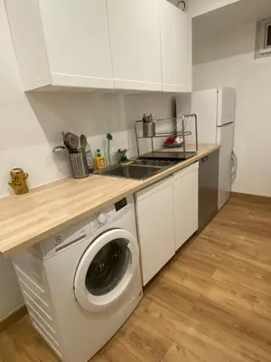 a kitchen with a washing machine and a sink at Superbe appartement de 3p pieces dans residence avec piscine et climatisation in Nice