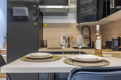 a kitchen with a table with plates and wine glasses at Casa feracci in Villefranche-sur-Mer