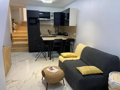 a living room with a couch and a kitchen at Casa feracci in Villefranche-sur-Mer