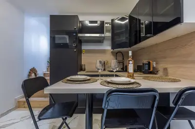a kitchen with a table with two glasses of wine at Casa feracci in Villefranche-sur-Mer