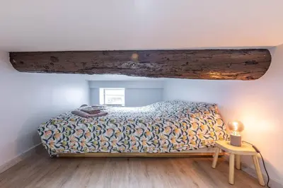 a bedroom with a bed and a wooden floor at Casa feracci in Villefranche-sur-Mer