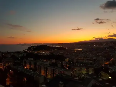 a city with a sunset in the background at 2 PIECEs BALCON VUE IMPRENABLE MER---VILLE---MONTAGNE in Nice
