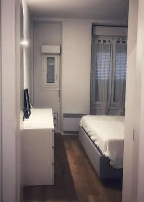 a small bedroom with a bed and a window at Suite Offenbach FSHH in Nice