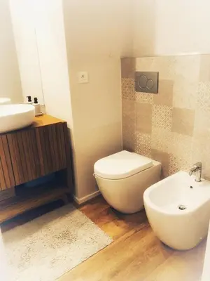 a bathroom with a white toilet and a sink at Suite Offenbach FSHH in Nice