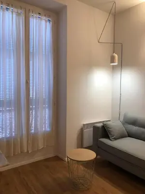 a living room with a couch and a table at Suite Offenbach FSHH in Nice
